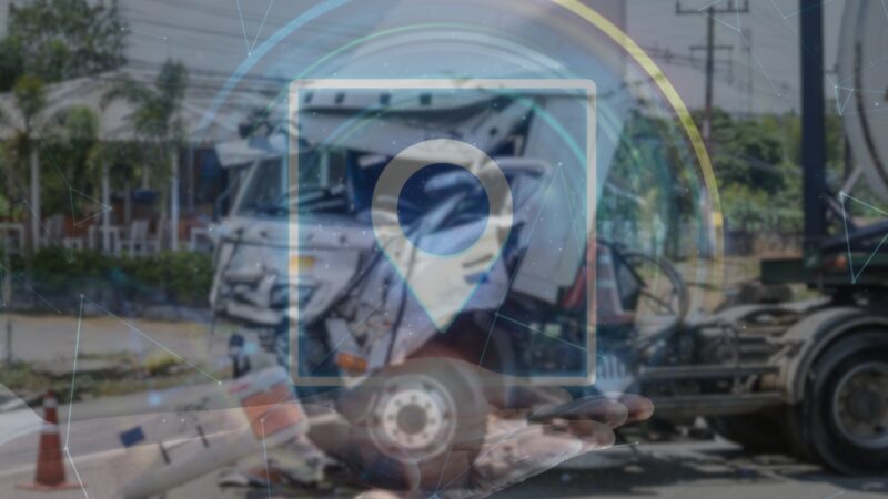 A Digital Overlay of A GPS Location Icon Over a Blurred Image of A Truck Accident Scene, Symbolizing the Role of Telematics and GPS Data in Analyzing and Resolving Truck Accident Lawsuits